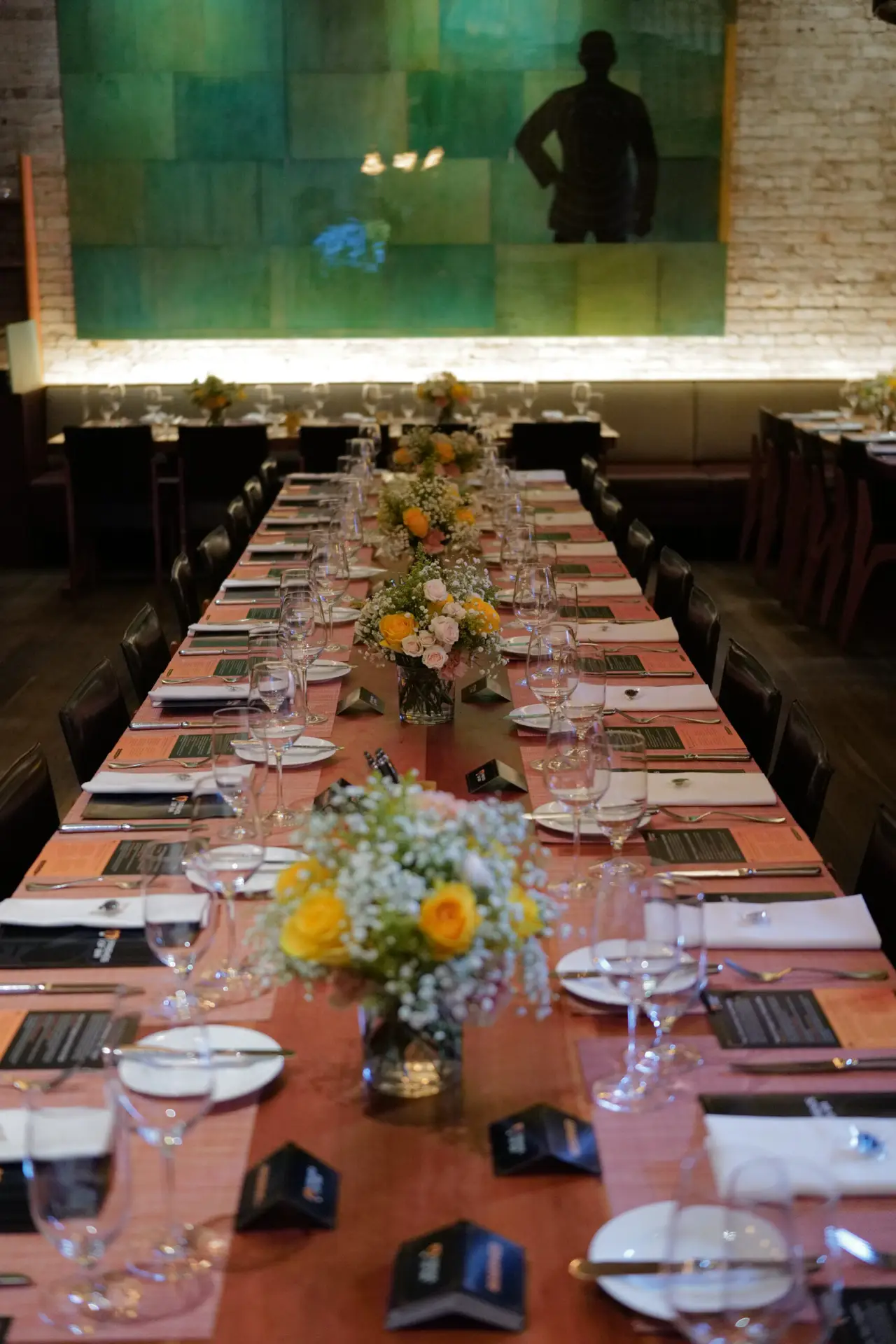 Long dinner table with florals at the DoBI Salon