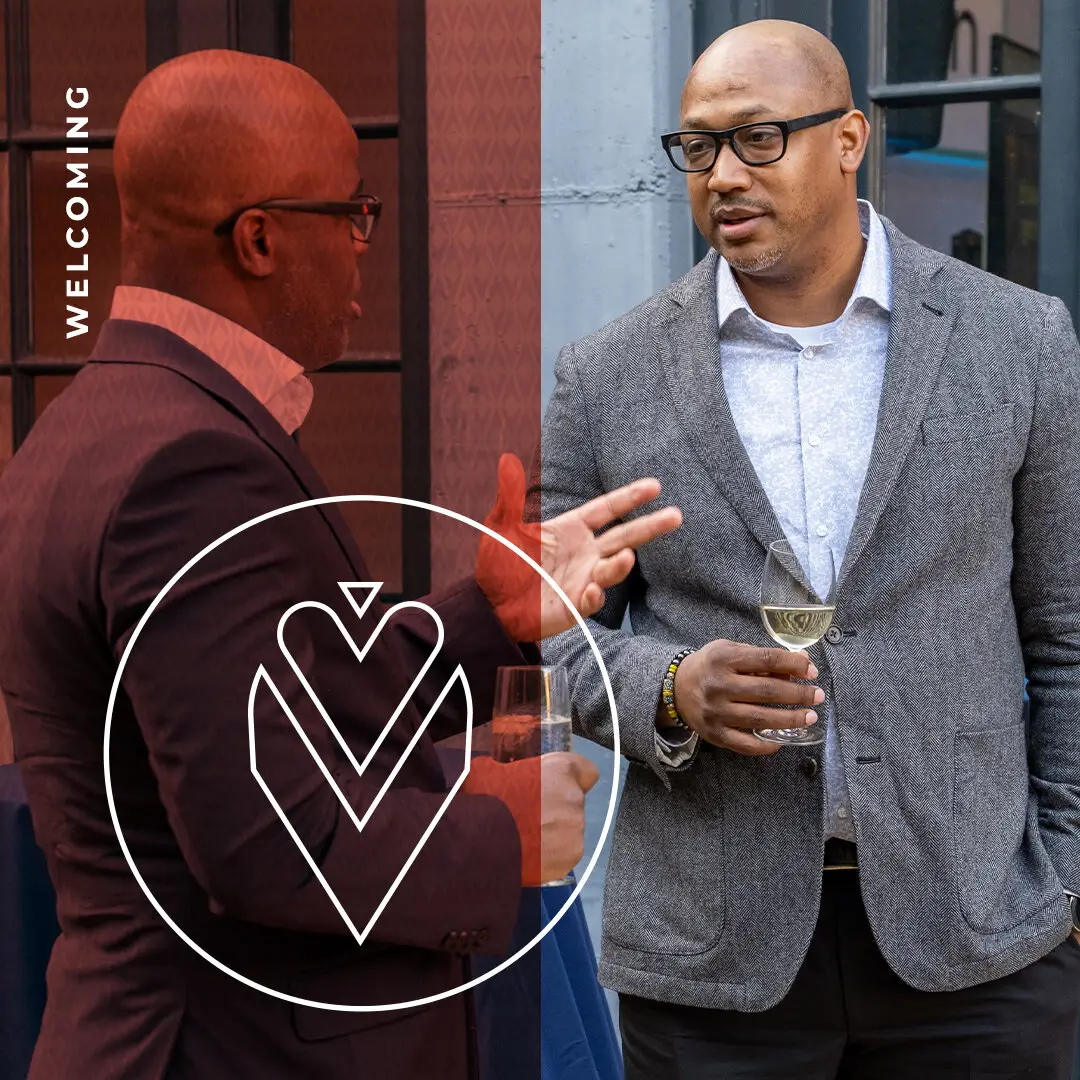 Welcoming value statement icon over two men in conversation at a reception