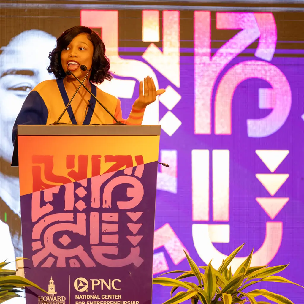 Speaker at the HBCU Empower branded podium with patterned stage graphics