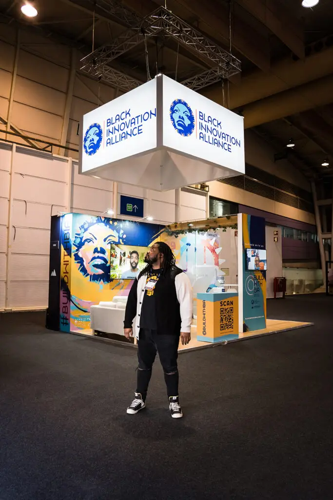 Black Innovation Alliance conference booth with hanging cube signage